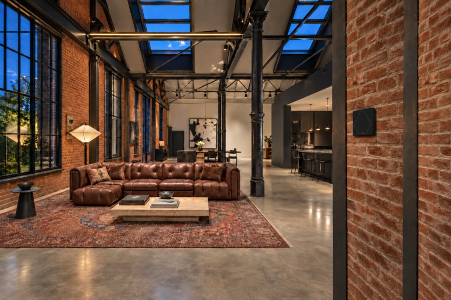 Loft industriel sous verrière, murs de brique et colonnes métalliques